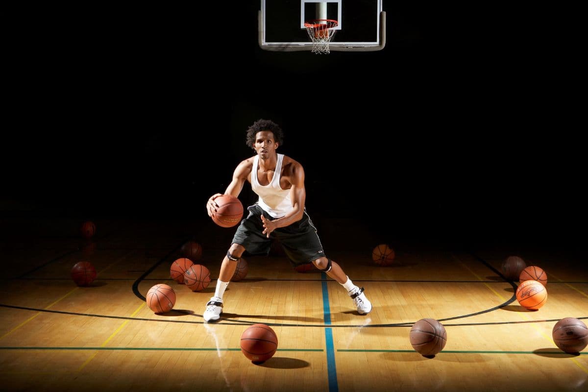 A young basketball player dribbling on an indoor court